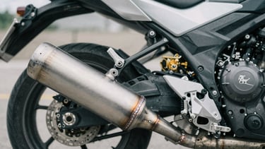 Close-up of custom motorcycle titanium exhaust weld, desaturated metallic tones, macro photography, 35mm film.