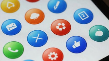 Macro shot of a high-resolution screen showing colorful, rounded UI buttons. International / European design style, vibrant but clean, focus on tactile detail.