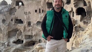 a man standing on a rock formation in a cave