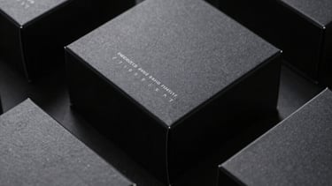 Still-life photography of premium black packaging for a luxury tech brand, featuring sharp corners and a subtle matte finish.