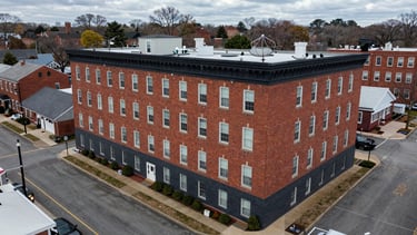 Overhead satellite view of 10 Burke Ave, Rowley, MA, showing the building and surrounding streets, crisp overcast daylight, high detail.