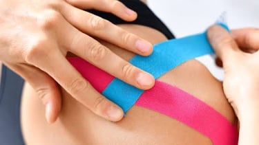 Kinesiology taping for sports injury recovery by physiotherapist