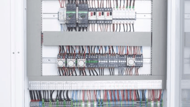 A large electrical cabinet of blast freezer with many wires and wires