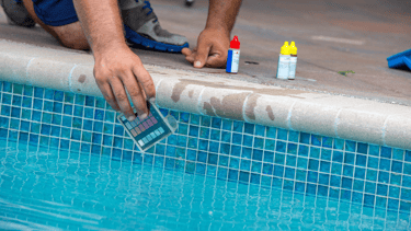 A pool tech is using chemical testing kit to test the PH balance and alkalinity