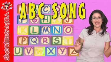 a woman standing in front of alphabet letters