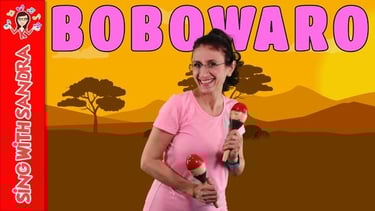 a woman in a pink shirt holding two marakas