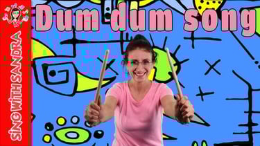 a woman holding a pair of drumsticks