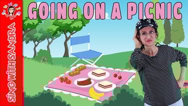 a woman in a striped shirt and a picnic blanket