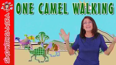 a woman standing in front of a camel herd