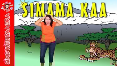 a woman in a orange shirt and jeans standing in front of a mountain