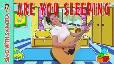 a woman holding a guitar and singing