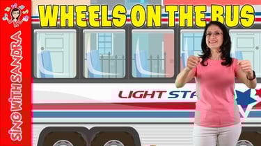 a woman in a pink shirt in front of a bus