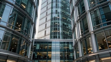 A professional photography of a high-tech corporate office lobby in Paris La Defense district, featuring sleek glass and steel architecture. The lighting is sophisticated, with deep navy and teal accents reflecting off polished surfaces. The scene conveys reliability and sovereign authority in digital infrastructure.