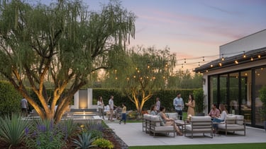 A family sitting together on a backyard patio surrounded by lush landscaping, enjoying the outdoor.