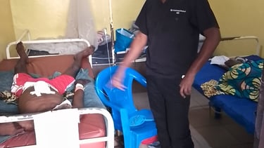 a man in a hospital room with a nurse and a nurse