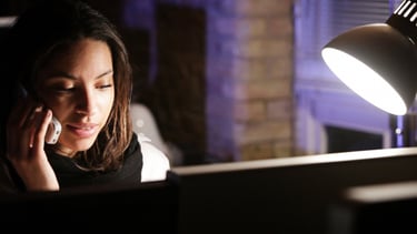 Woman receiving private spiritual guidance and confidential support during a nighttime consultation