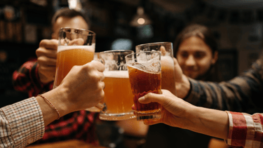 a group of people toasting with beer