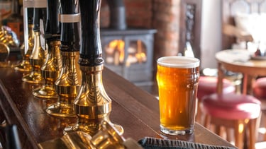 a glass of beer in a bar