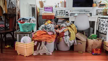 a messy desk surrounded by piles of clutter