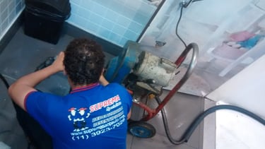 técnico de desentupimento com maquinário executando um desentupimento de ralo na liberdade