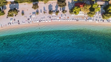 a beach with umbrellas on the beach, croatia
