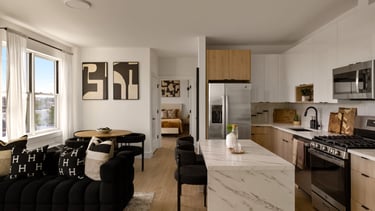Modern open-plan kitchen and living room with natural light.