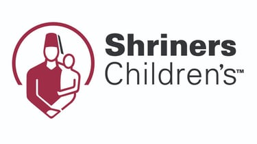 Shriners Children's TM logo with 3/4 circle and person wearing a fez hat holding smaller person