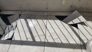 Pedestal tiles broken by small pebbles dropped by birds
