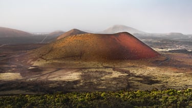 a mountain with a red and yellow mountain in the background