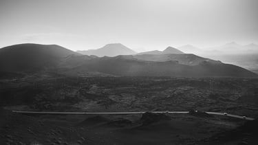 a mountain scene with a road and a car