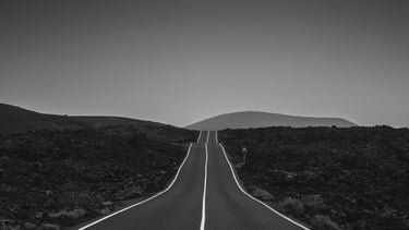 a long road with a road sign on it
