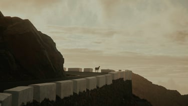 a animal standing on a hill with a mountain in the background