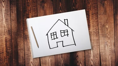 Carnet de papier avec une maison dessiné 