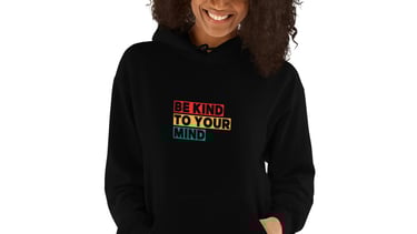 a woman wearing a black hoodie with the words be kind of you
