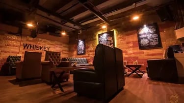 a bar with a couch and a bar stool
