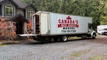 Canada’s Most Wanted Movers truck parked at a forest-side home in the Lower Mainland during a residential move.