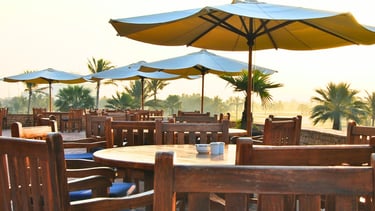 the club house with a table with a plate of food and a drink