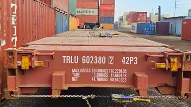 Red 40ft Flat Rack showing 98,540 Lbs. weight capacity