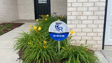 a sign that says,'C and R Security solutions,'the sign is for the security company that protects