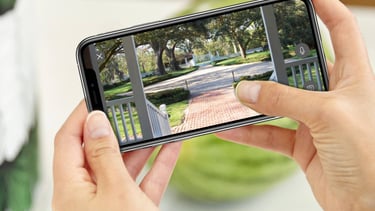 a person taking a picture of a house with a camera