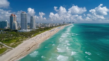 Aerial View of a Sunny Beachfront Cityscape with Azure Waters and White Sand