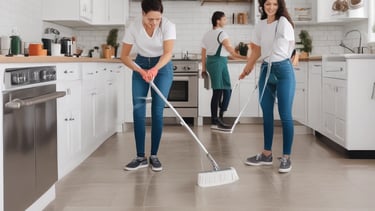 A group of people inside a room engage in cleaning or maintenance activities. One person sweeps the floor with a broom while others stand and observe, smiling or gesturing. The room has wooden structures and a child rests on a bed nearby.