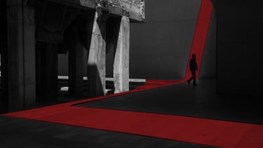 a person walking down a street with a red carpet