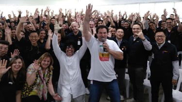 a group of people standing in front of a crowd of people