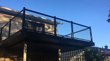 a balcony with a balcony and a balcony with a glass railing