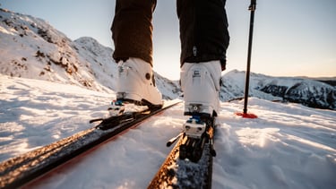 a person standing on skis in the snow
