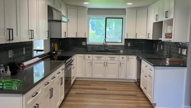 Vinyl Plank flooring, remodeled kitchen with white cabinets and gray counter tops