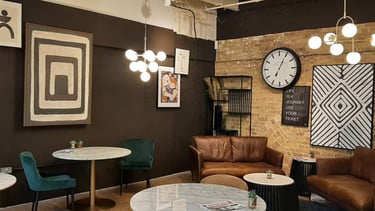 cafe with a clock and chairs and wall art