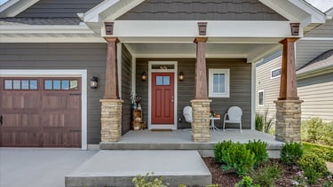 a house with a red door and a white chair