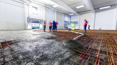 a group of workers working on a large floor